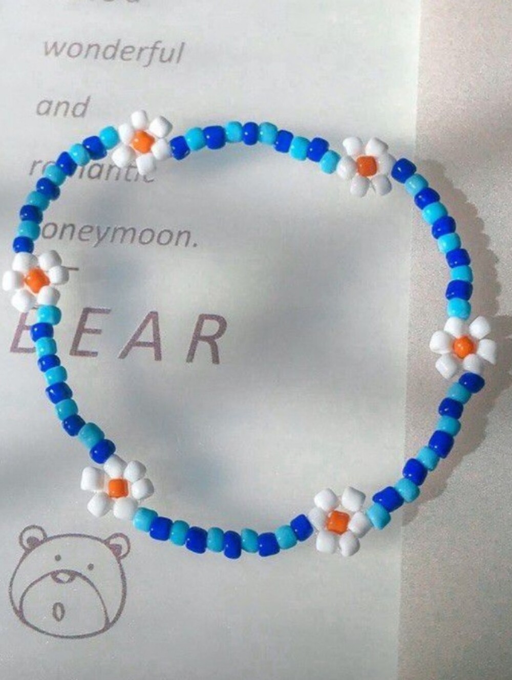 Blue Beaded Daisy Bracelet with White & Orange Accents